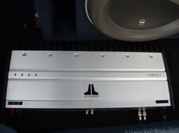 JL Audio amplifier on the left